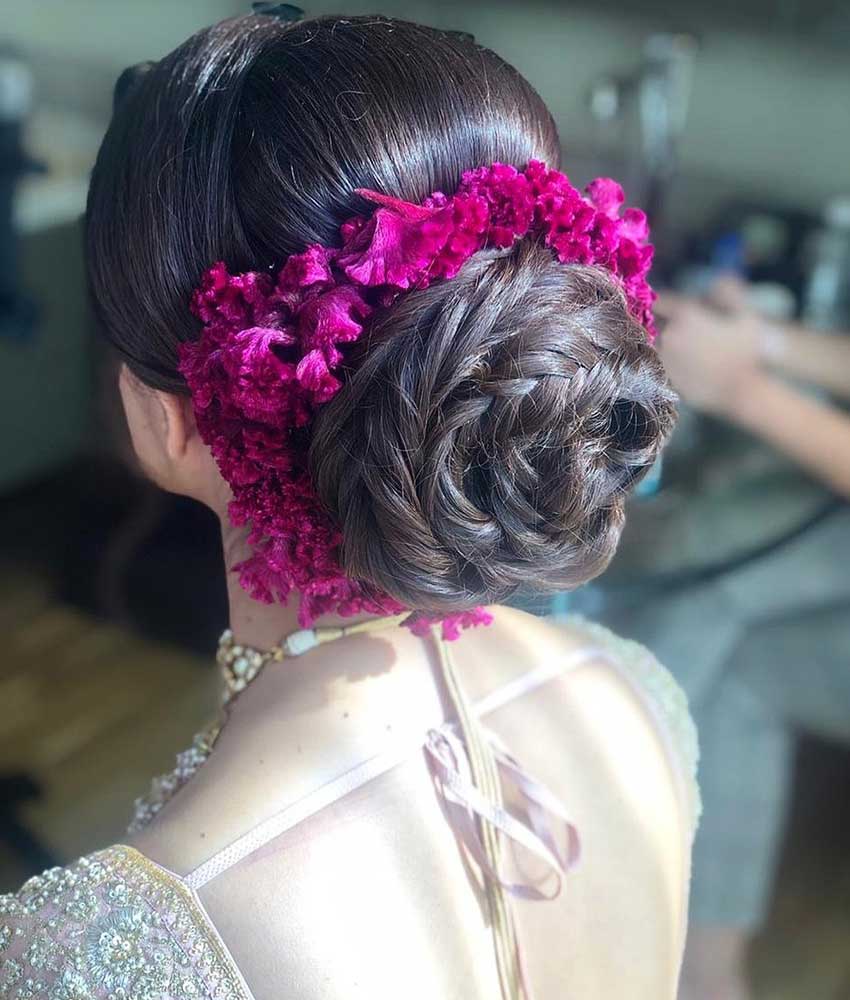 Jasmine Beauty Care - This bridal bun with a bunch of colorful flowers and  baby breath's flower is perfect to wear with your bridal lehenga on your  big day. This hairstyle is